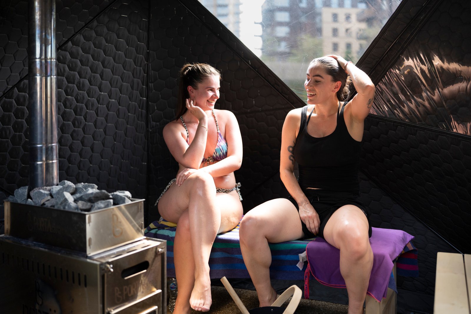 Two people connecting in conversation inside the SMÜG sauna